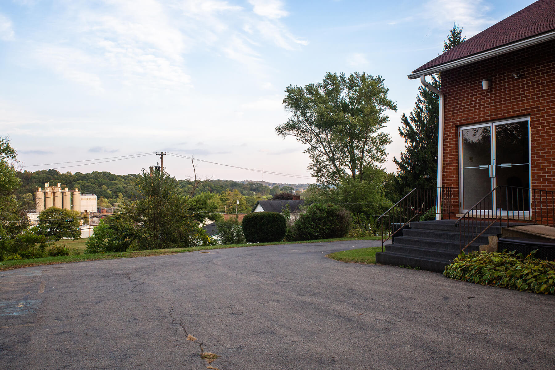 Rev. William Hogans is the pastor of St. Luke A.M.E. Zion Church. The entrance to St. Luke is pictured, overlooking the West Side of New Castle with a view of the Resco Products New Castle plant in the background.