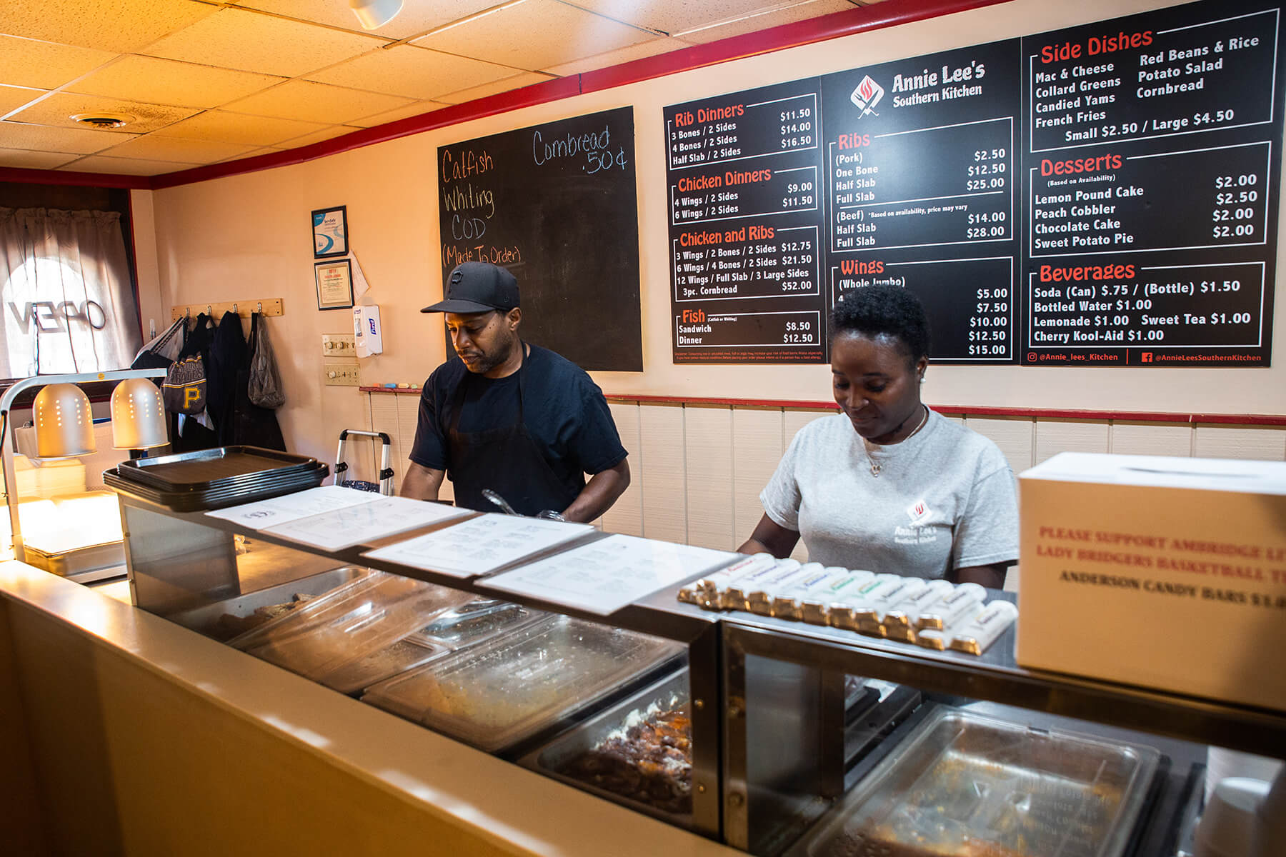 Terry Stenhouse (left) works with Lethera Harrison behind the counter of Annie Lee’s Southern Kitchen.